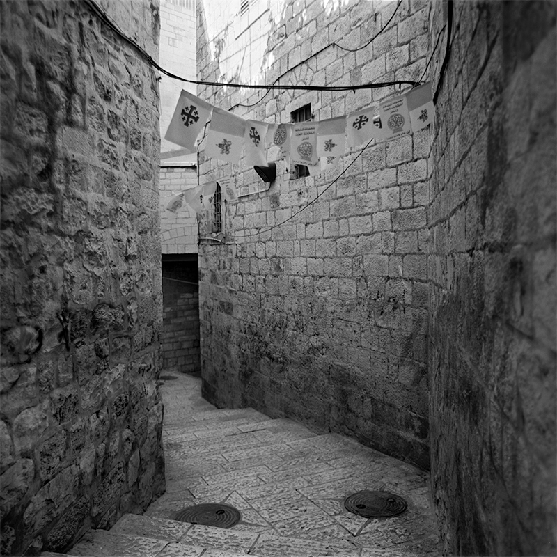 Black and white square photo of an alleyway in the old city of Jerusalem