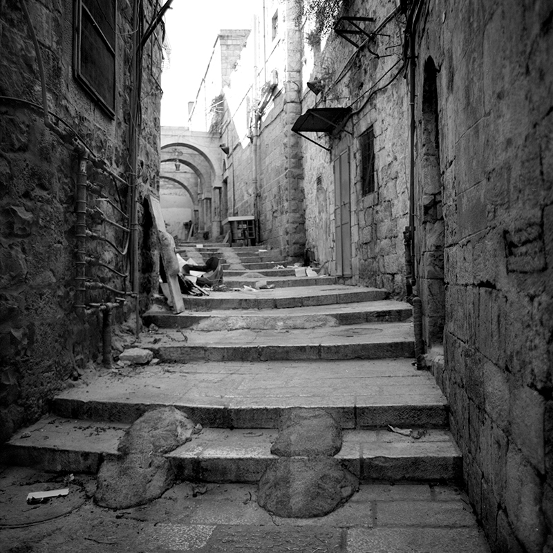 Black and white square photo of an alleyway in the old city of Jerusalem