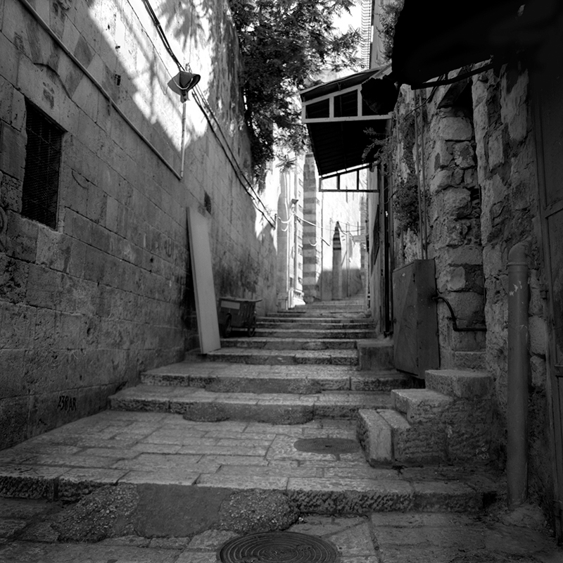 Black and white square photo of an alleyway in the old city of Jerusalem