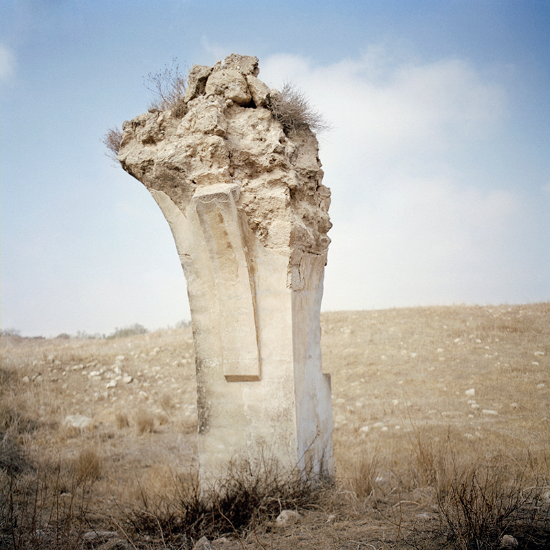 Lone arc column remains in barren field