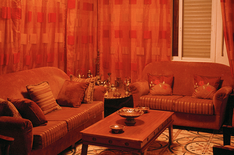 Living room with orange furniture and curtains