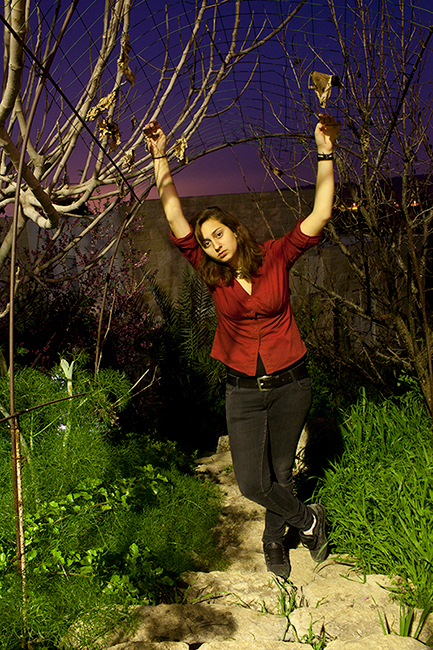 Young woman in red shirt in nighttime against purple skies