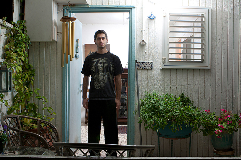 Young man standing in home's doorway